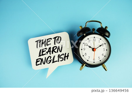 Time To Learn English text on speech bubble with alarm clock on blue background Time To Learn English text on speech bubble with alarm clock on blue background 136649456
