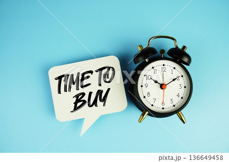 Time To Buy text on speech bubble with alarm clock on blue background 136649458