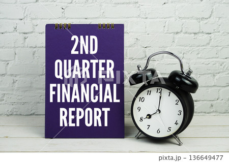 2nd Quarter Financial Report text with alarm clock on white brick wall and wooden background 136649477