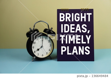 Bright Ideas, Timely Plans text with alarm clock on yellow and blue background Bright Ideas, Timely Plans text with alarm clock on yellow and blue background 136649484