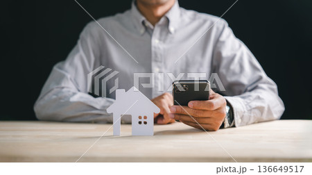 Person holds smart phone for home real estate property search, exploring detailed house information online with mobile app, planning new investment for future dreams Person holds smart phone for home real estate property search, exploring detailed house information online with mobile app, planning new investment for future dreams 136649517
