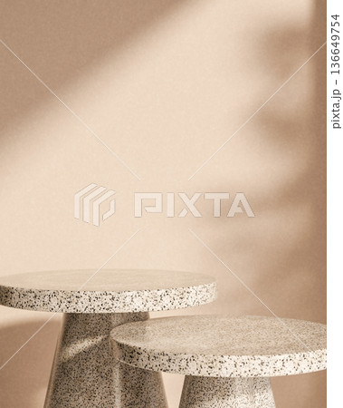 Round granite stone table display platform with sunlight shadow on plain concrete wall background. 136649754