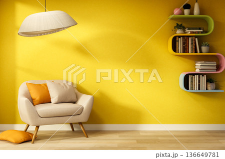 White armchair with cushions under lamp and rainbow bookshelf on yellow wall with sunlight shining. 136649781