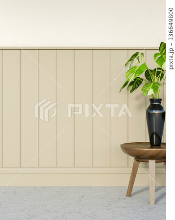 Green plant in black vase on wooden table over stone floor corridor aside beige slats on white wall. Green plant in black vase on wooden table over stone floor corridor aside beige slats on white wall. 136649800