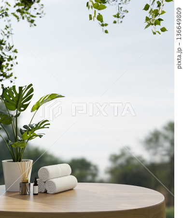White towels and aroma diffuser aside potted plant on round wooden table with forest scenery and sky White towels and aroma diffuser aside potted plant on round wooden table with forest scenery and sky 136649809