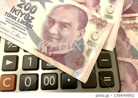 Turkish Lira and Calculator Finance Concept. 200 TRY banknotes on calculator representing Turkish economy, budgeting, and financial planning. 200 Turkish Lira banknotes placed on a black calculator.  136649902