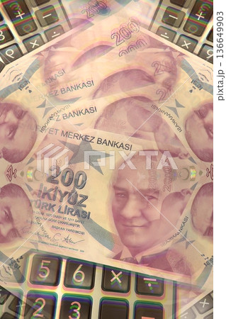 Turkish Lira and Calculator Finance Concept. 200 TRY banknotes on calculator representing Turkish economy, budgeting, and financial planning. 200 Turkish Lira banknotes placed on a black calculator. Turkish Lira and Calculator Finance Concept. 200 TRY banknotes on calculator representing Turkish economy, budgeting, and financial planning. 200 Turkish Lira banknotes placed on a black calculator. 136649903