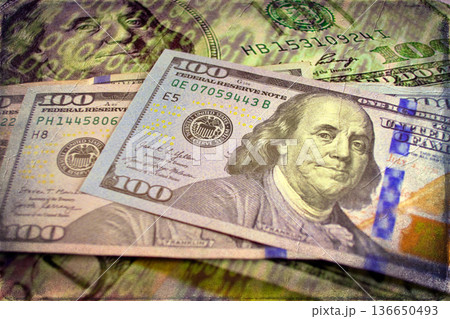 Vintage Style Stack of US Hundred Dollar Bills. A textured, old-photo effect overlaying a pile of $100 American banknotes, highlighting financial concepts and wealth. 136650493