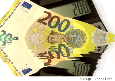 Calculator and Euro Bills. A professional stock photo of 200 euro banknotes on a calculator. Calculator and Euro Bills. A professional stock photo of 200 euro banknotes on a calculator. 136651767