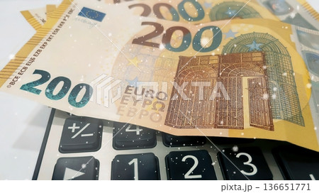 Calculator and Euro Bills. A professional stock photo of 200 euro banknotes on a calculator. 136651771
