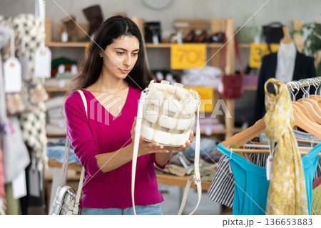 Armenian woman choosing a fashionable handbag Armenian woman choosing a fashionable handbag 136653883