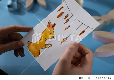 Person holding handmade greeting card. Gesture shows excitement and joy for the upcoming event. Springtime holiday gift present zero cost ideas. Creative art Person holding handmade greeting card. Gesture shows excitement and joy for the upcoming event. Springtime holiday gift present zero cost ideas. Creative art 136655243
