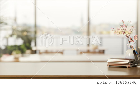 Books and pencil aside flower vase on wooden counter table across window wall in living room or cafe 136655546