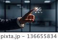 Businessman Pointing at Glowing 5G Network Technology Interface 136655834