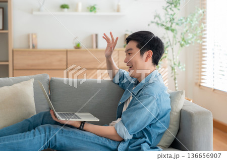 Young Asian man relaxing on comfortable couch 136656907