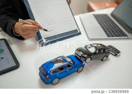 Female signing car insurance document or lease. Female signing car insurance document or lease. 136656989