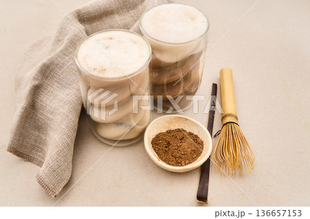 Hojicha lattes with roasted green tea powder and whisk Hojicha lattes with roasted green tea powder and whisk 136657153