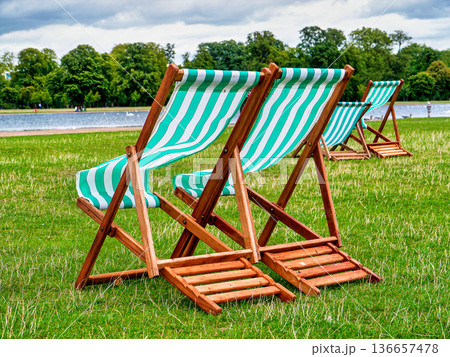 Striped deck chairs at Kensington Gardens, London, UK. Striped deck chairs at Kensington Gardens, London, UK. 136657478