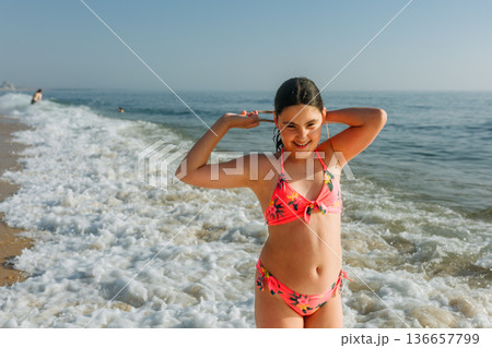 portrait of a teenage girl standing on the beach portrait of a teenage girl standing on the beach 136657799