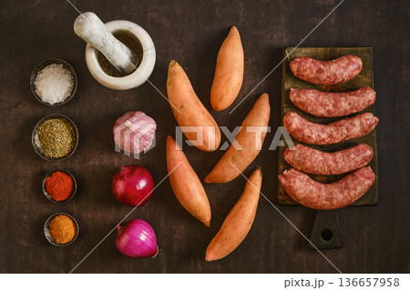 Natural casing sausages with sweet potatoes and spices on a wooden table during daytime Natural casing sausages with sweet potatoes and spices on a wooden table during daytime 136657958