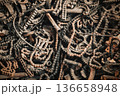 Rusty Chains and Gears in Industrial Scrap Heap, Chaotic Background of Corroded Metal Parts, Machinery and Mechanical Components from Abandoned Factory Recycling Yard. High quality photo 136658948