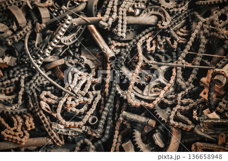 Rusty Chains and Gears in Industrial Scrap Heap, Chaotic Background of Corroded Metal Parts, Machinery and Mechanical Components from Abandoned Factory Recycling Yard. High quality photo 136658948