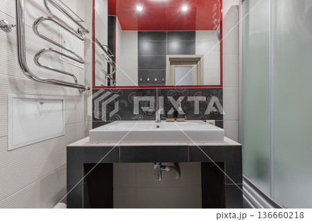 Modern Bathroom Interior with Red Ceiling and Black Tile Accents Modern Bathroom Interior with Red Ceiling and Black Tile Accents 136660218