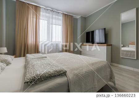 Modern Minimalist Bedroom Interior with TV and Sage Green Walls 136660223