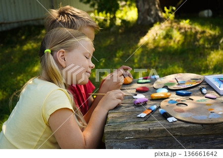 Each painted stone reflects a child's imagination, carefully created as a DIY gift full of personal charm. Each painted stone reflects a child's imagination, carefully created as a DIY gift full of personal charm. 136661642