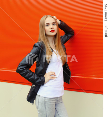 Beautiful modern young blonde woman in black leather jacket, stylish girl posing on city street Beautiful modern young blonde woman in black leather jacket, stylish girl posing on city street 136661745