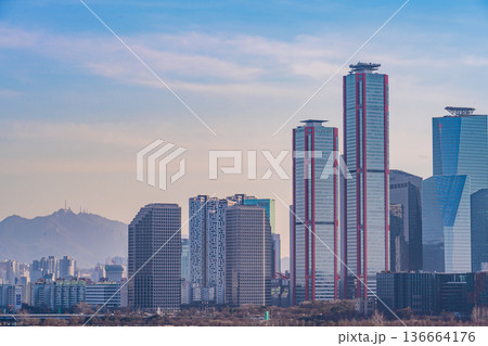 Seoul, Korea - Feb. 16, 2026 : A building in Yeouido, Seoul's financial district in Korea, taken just before sunset, and the cityscape of the Han River 136664176