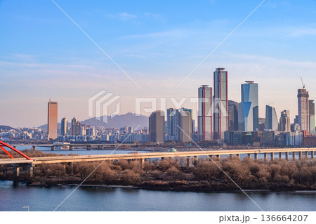 Seoul, Korea - Feb. 16, 2026 : A building in Yeouido, Seoul's financial district in Korea, taken just before sunset, and the cityscape of the Han River Seoul, Korea - Feb. 16, 2026 : A building in Yeouido, Seoul's financial district in Korea, taken just before sunset, and the cityscape of the Han River 136664207