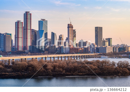 Seoul, Korea - Feb. 16, 2026 : A building in Yeouido, Seoul's financial district in Korea, taken just before sunset, and the cityscape of the Han River Seoul, Korea - Feb. 16, 2026 : A building in Yeouido, Seoul's financial district in Korea, taken just before sunset, and the cityscape of the Han River 136664212
