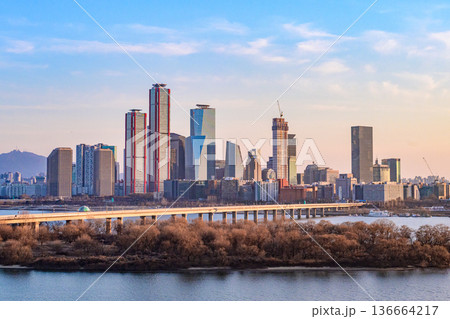 Seoul, Korea - Feb. 16, 2026 : A building in Yeouido, Seoul's financial district in Korea, taken just before sunset, and the cityscape of the Han River Seoul, Korea - Feb. 16, 2026 : A building in Yeouido, Seoul's financial district in Korea, taken just before sunset, and the cityscape of the Han River 136664217