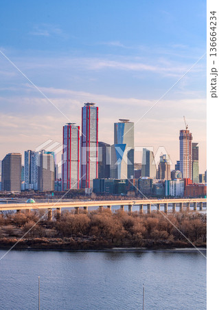 Seoul, Korea - Feb. 16, 2026 : A building in Yeouido, Seoul's financial district in Korea, taken just before sunset, and the cityscape of the Han River 136664234