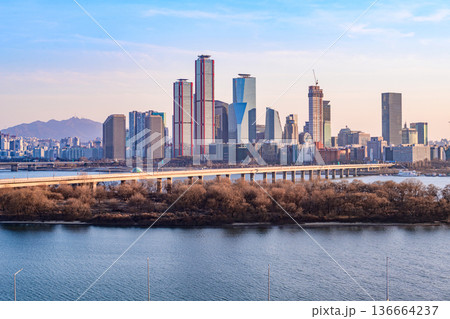 Seoul, Korea - Feb. 16, 2026 : A building in Yeouido, Seoul's financial district in Korea, taken just before sunset, and the cityscape of the Han River 136664237