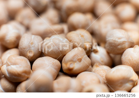 Close-up macro of raw chickpea kernels in a clear storage jar 136665256