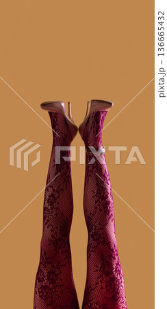 Female legs in lace tights and nude heels symmetrical pose on beige background. Female legs in lace tights and nude heels symmetrical pose on beige background. 136665432