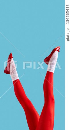 Female legs in red tights and red pumps on blue background. Female legs in red tights and red pumps on blue background. 136665458