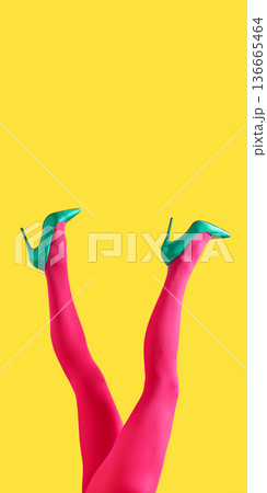 Female legs in green heels and pink tights lifted on yellow backdrop Female legs in green heels and pink tights lifted on yellow backdrop 136665464