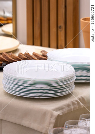 Many white different plates stacked together Many white different plates stacked together 136666721
