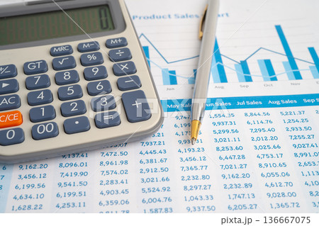 Pencil and calculator on chart or graph paper. Financial, account, statistics and business data. 136667075