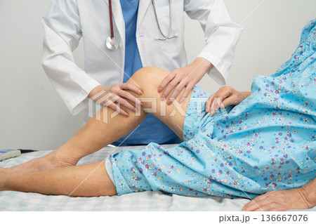 Doctor checking Asian elderly woman patient knee replacement surgery in hospital. Doctor checking Asian elderly woman patient knee replacement surgery in hospital. 136667076