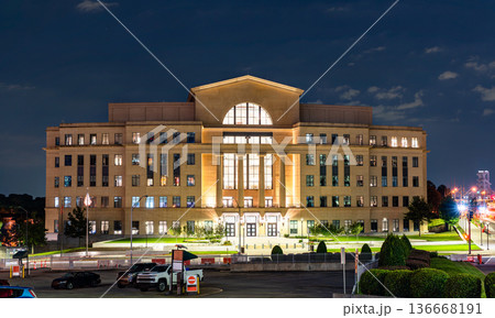 Nathan Deal Judicial Center in Atlanta, Georgia. Modern government building features a stone facade with columns and large glass windows illuminated at night 136668191