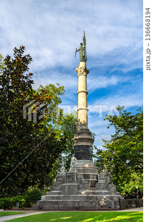 Confederate Memorial Monument in Montgomery Alabama. Historic stone column features bronze statues honoring Civil War soldiers on the State Capitol grounds under a blue sky 136668194