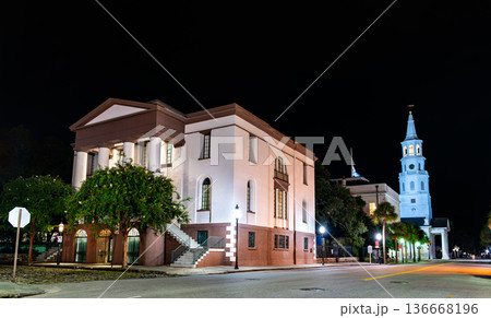 Fireproof Building in Charleston, South Carolina. Historic Greek Revival architecture features a brownstone base and white columns near St. Michaels Church at night 136668196