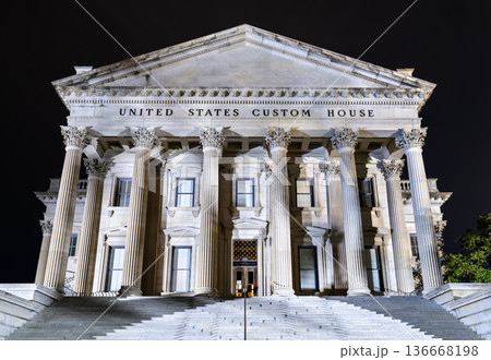United States Custom House in Charleston, South Carolina. Historic Neoclassical building features massive Corinthian columns and steps illuminated at night 136668198