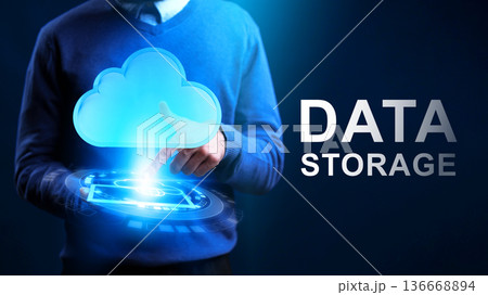 Cloud data storage technology in use with a hand pointing at a cloud symbol on a screen Cloud data storage technology in use with a hand pointing at a cloud symbol on a screen 136668894