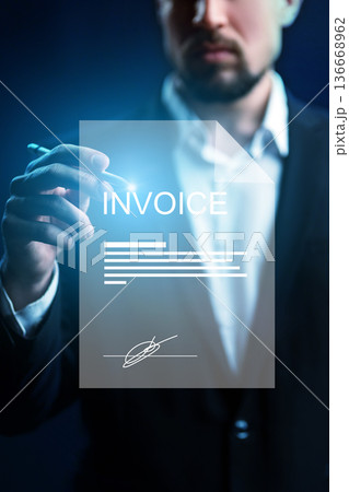 Handwriting on an invoice during a banking payment process in a dark office space Handwriting on an invoice during a banking payment process in a dark office space 136668962