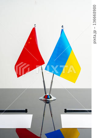 China and Ukraine flags displayed together on a table during a meeting for discussions 136668980